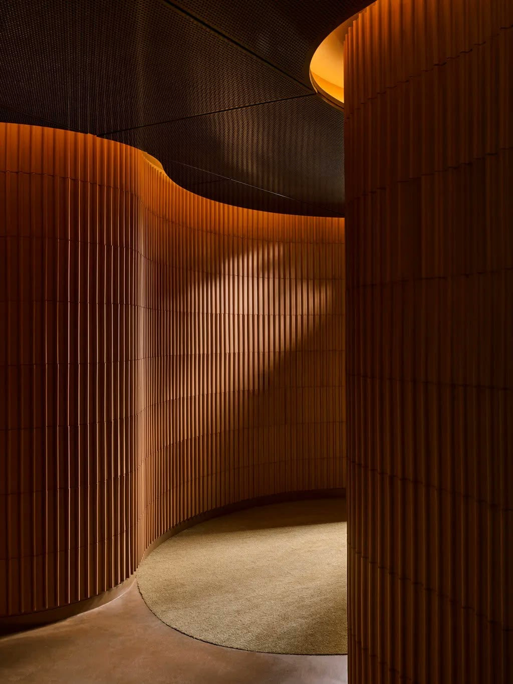 Warm terracotta curved corridor